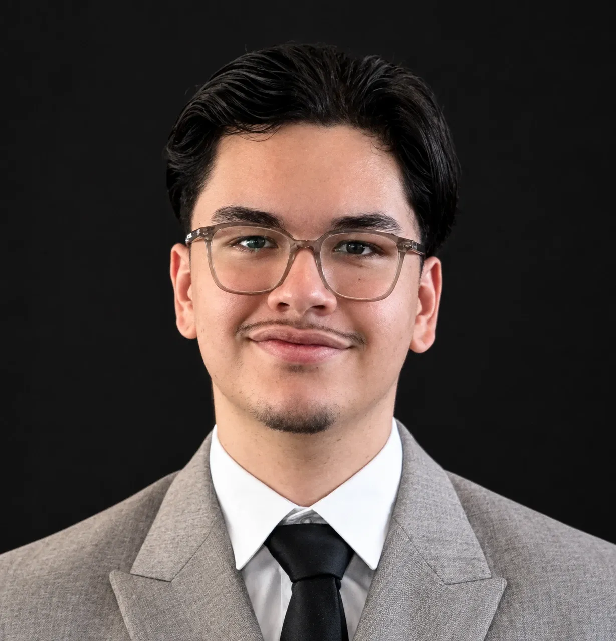 Portrait of Philippos Melikidis in a grey suit and glasses